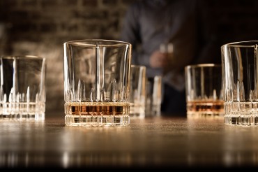 Werbefotografie Fotostudio Oberfranken Teilweise gefüllte Whiskeygläser der Spiegelau Perfect Serve Collection by Stephan Hinz auf Bartresen. Feigefotodesign